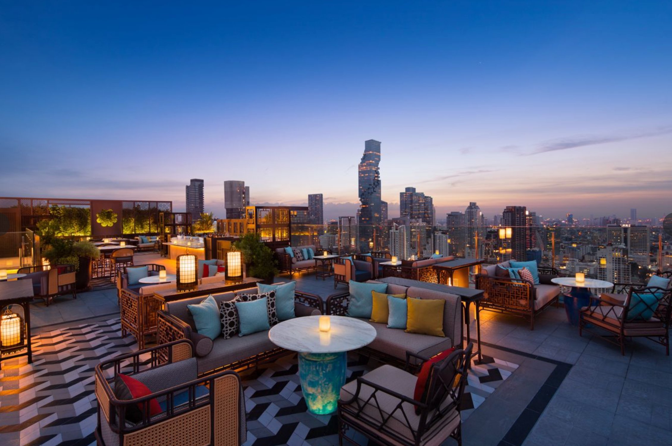 The rooftop bar at dusk with the MahaNakhon tower in the distance