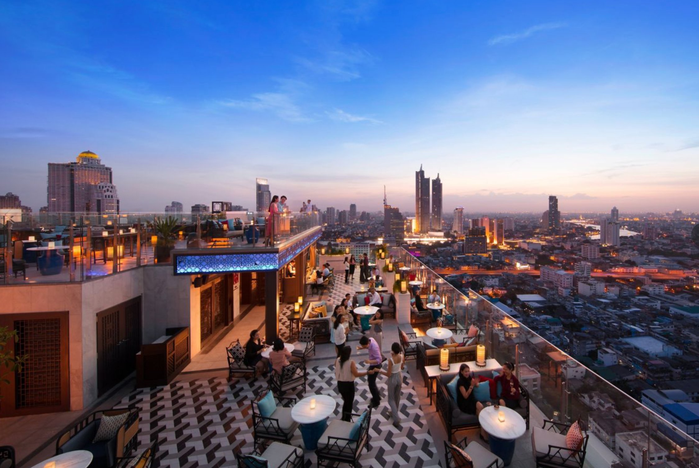The rooftop bar at twilight, looking out at Bangkok at sunset